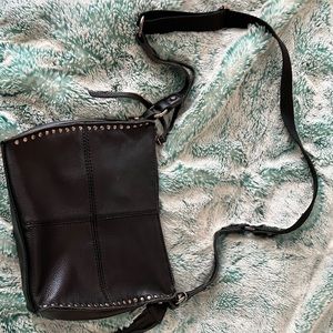The sak black purse with gold hardware